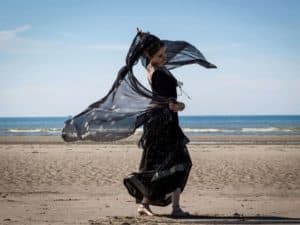 Woman in black on beach