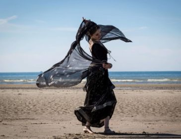 Woman in black on beach