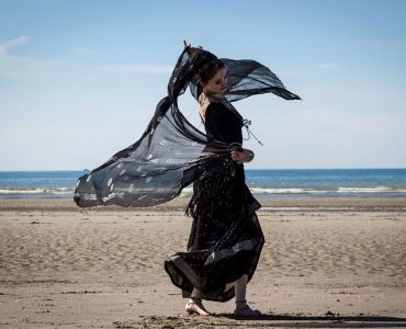 Woman in black on beach